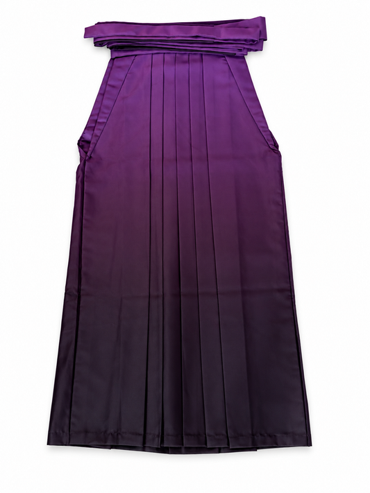A purple pleated traditional Japanese hakama with a wide waistband and tie detail, shown flat against a white background.