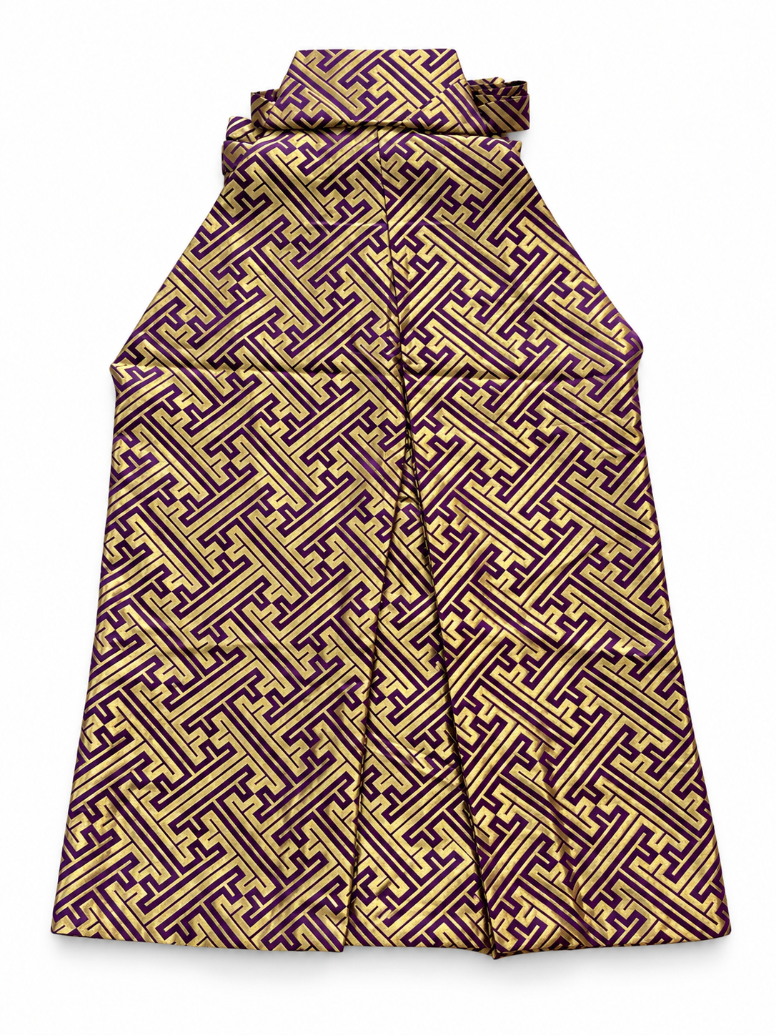 The back side of a traditional Japanese pants hakama featuring an intricate geometric maze-like pattern in purple and gold, shown against a plain white background.