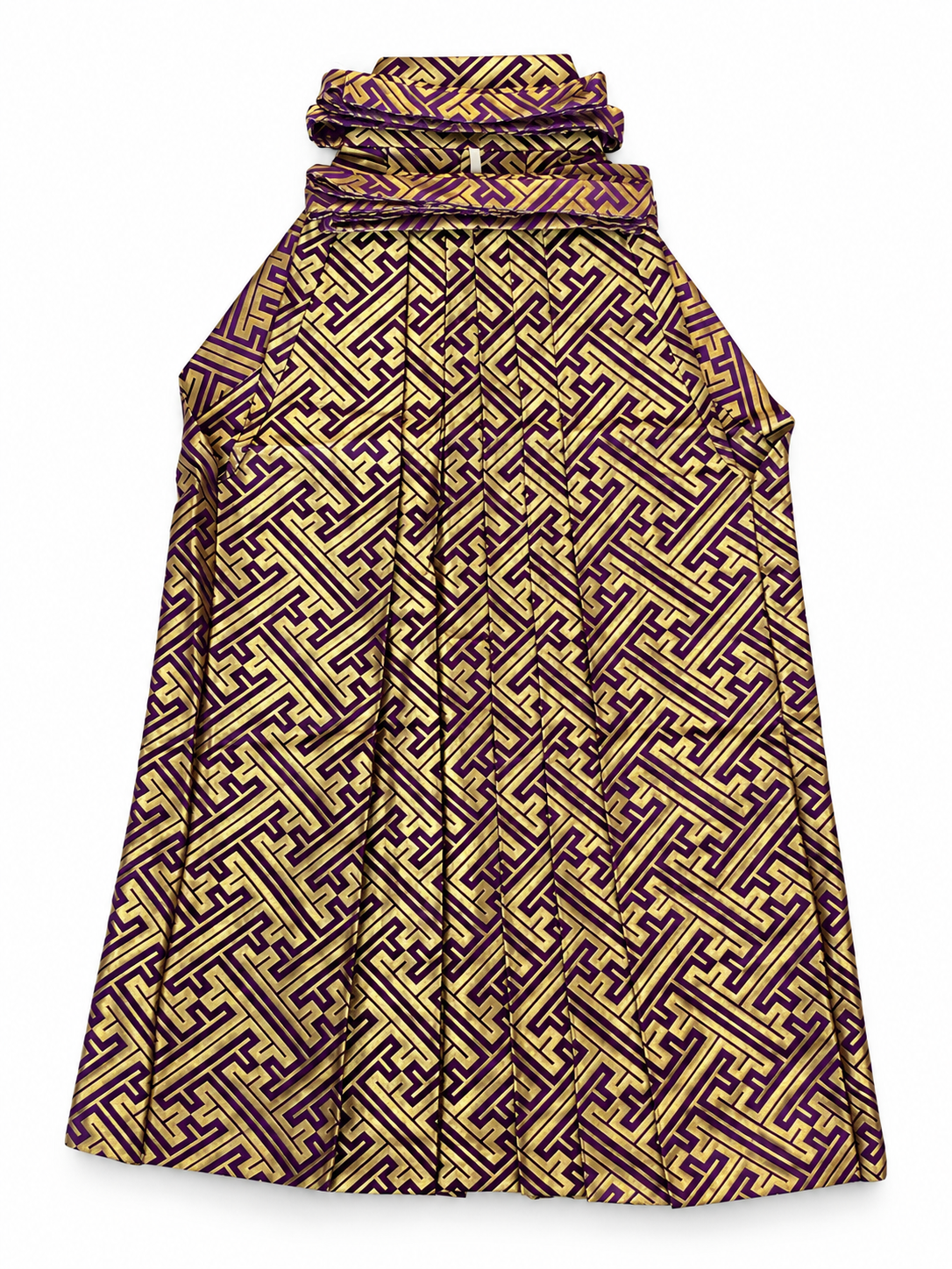 A traditional Japanese pants hakama featuring an intricate geometric maze-like pattern in purple and gold, shown against a plain white background.