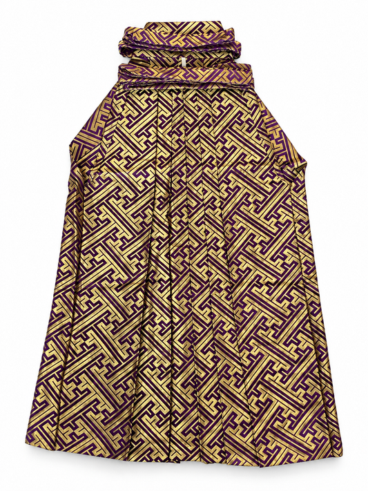 A traditional Japanese pants hakama featuring an intricate geometric maze-like pattern in purple and gold, shown against a plain white background.