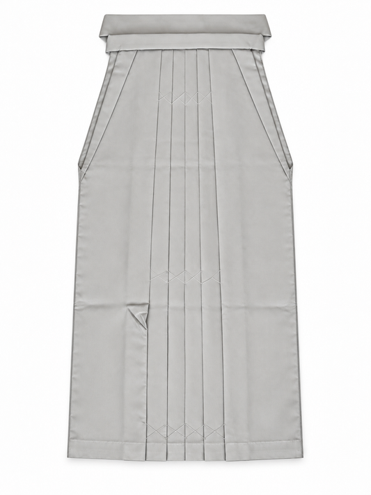 A light gray pleated traditional Japanese hakama skirt with a structured waistband and front pleats, shown flat against a white background.