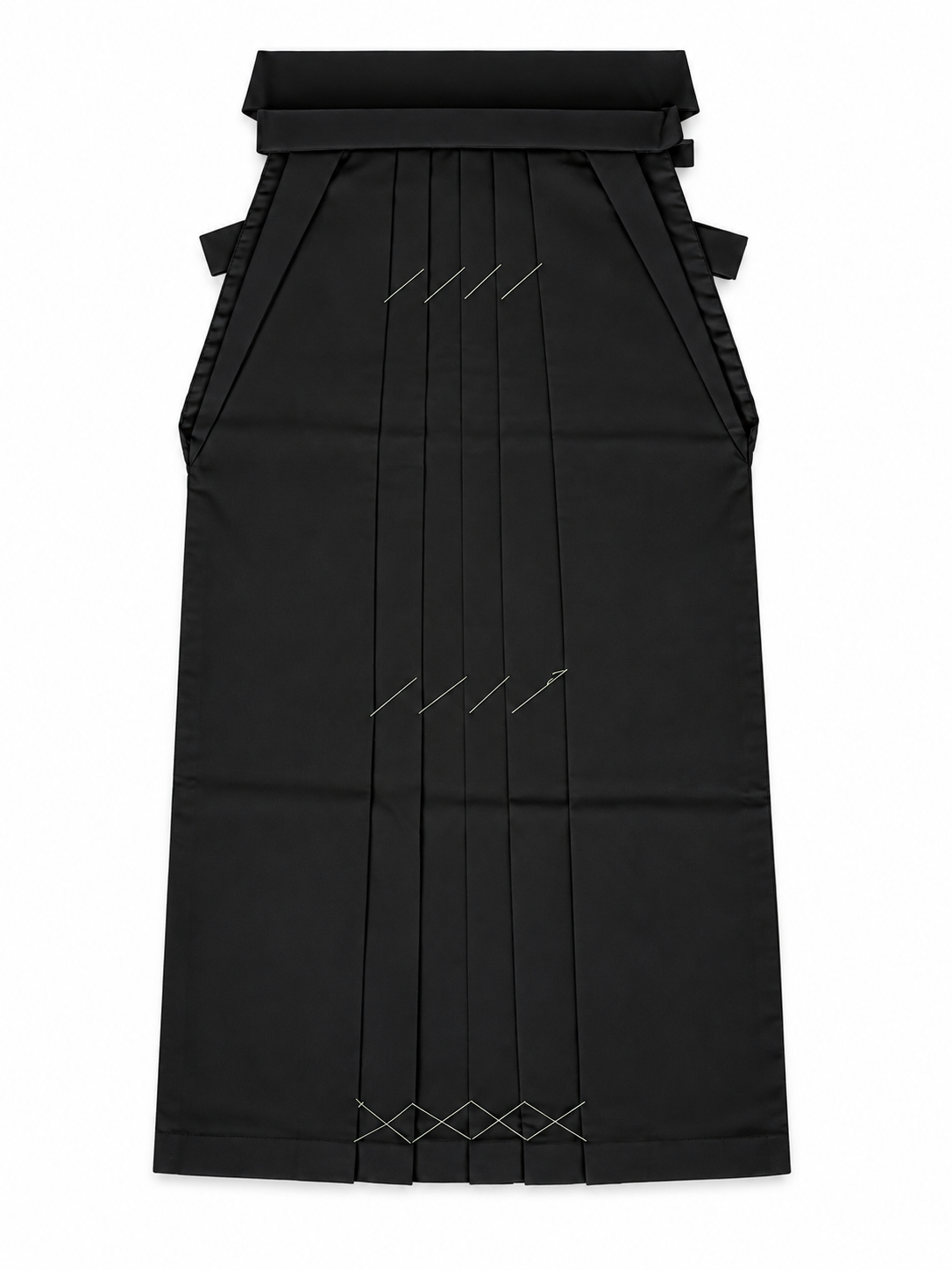 A black traditional Japanese hakama skirt with  vertical front pleats accented with geometric white stitched details, shown against a plain white background.