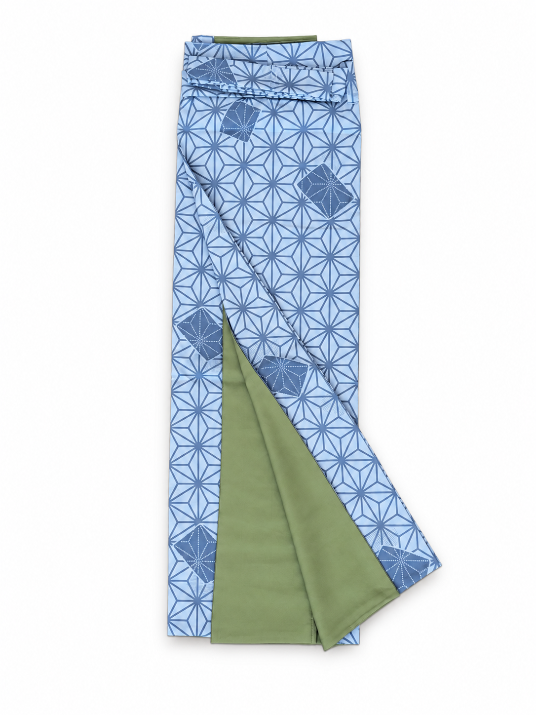 A folded pair of patterned skirt with a blue and white geometric floral design and an olive green reverse side, shown on a plain white background.