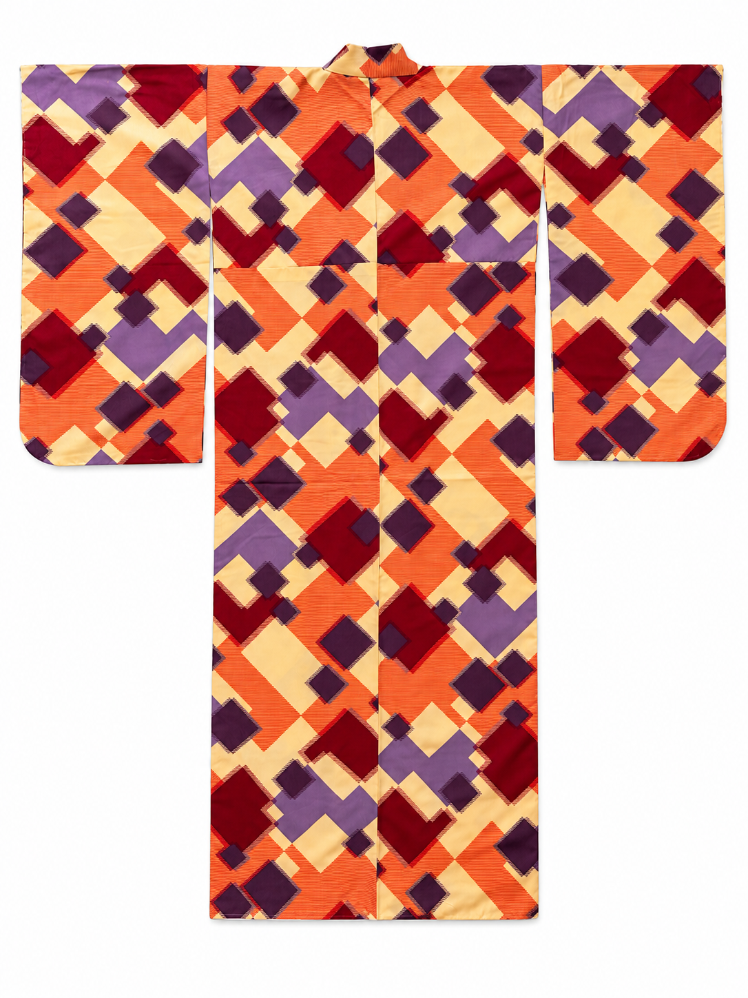 A furisode kimono garment laid flat on a white background, featuring an all-over geometric pattern of orange, red, purple, and cream diamond and square shapes.