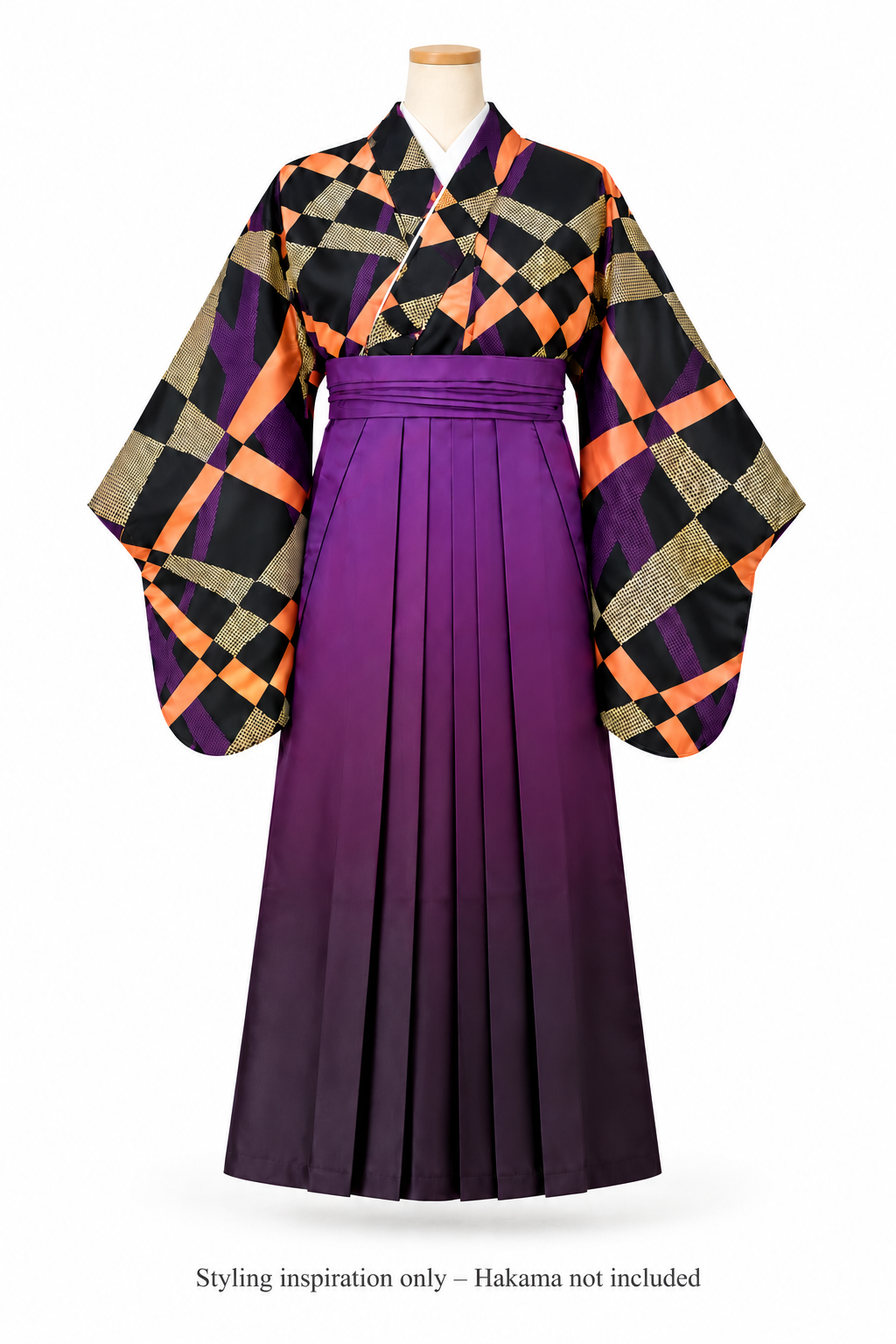 A traditional Japanese-style formal outfit displayed on a mannequin against a plain white background. The garment features a pleated purple hakama skirt and wide patterned sleeves with a black, orange, and beige geometric design. With a message at the botton "Styling inspiration only - hakama not included"